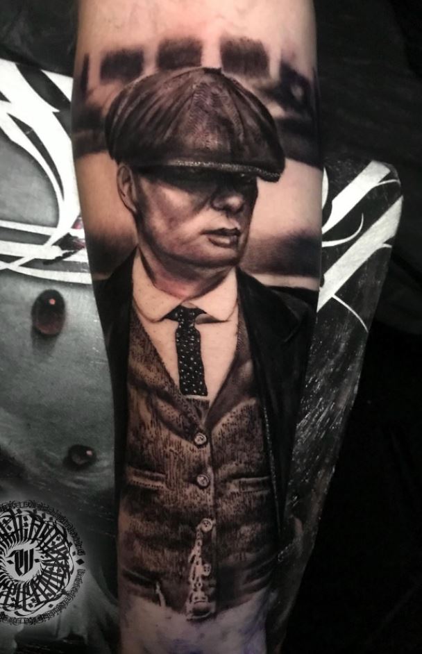 Tommy Shelby portrait tattoo located on the upper arm